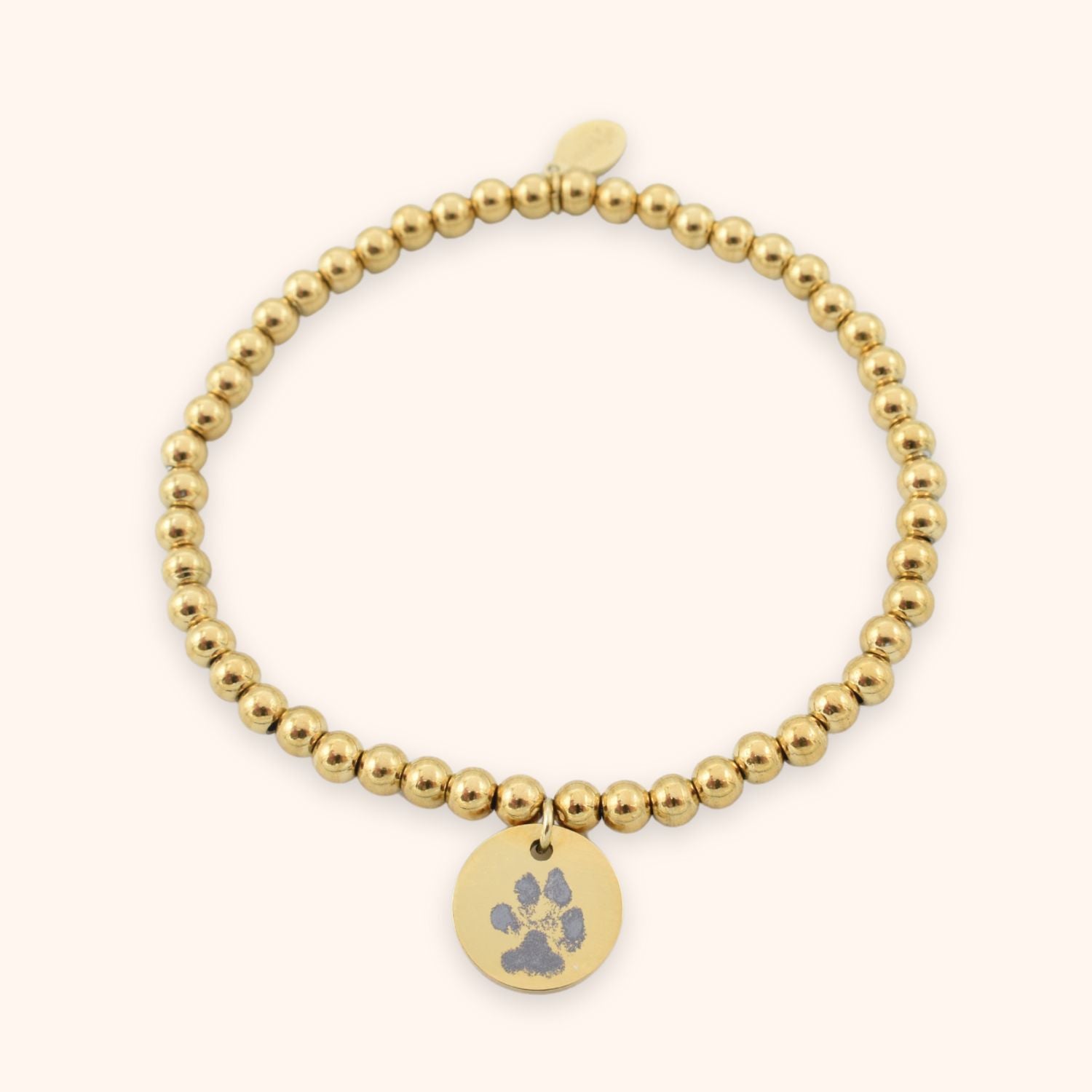 Dames armband pootafdruk gegraveerd op rond muntje goud stainless steel