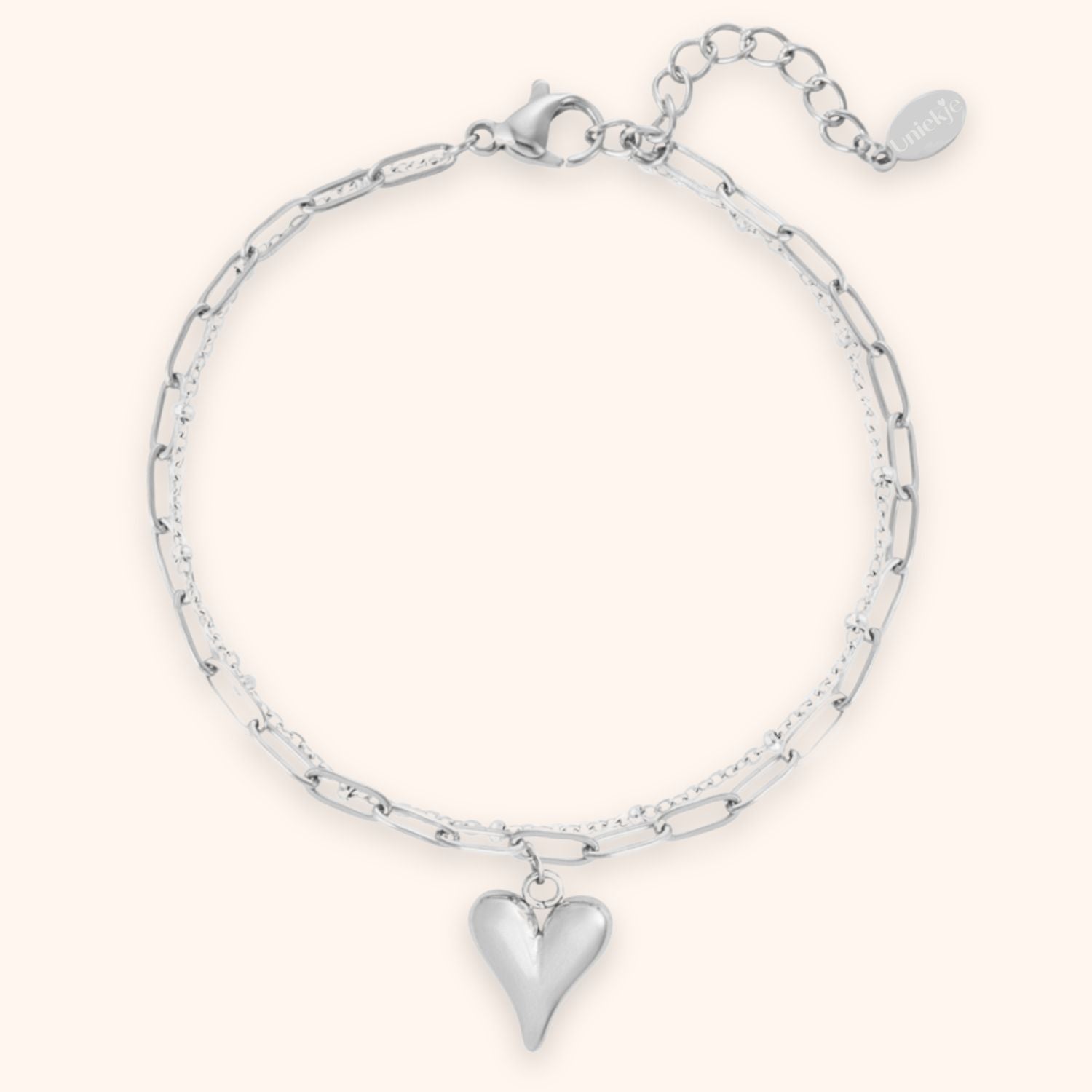 Zilverkleurige dubbele schakelarmband voor dames met hart bedel gemaakt van stainless steel.